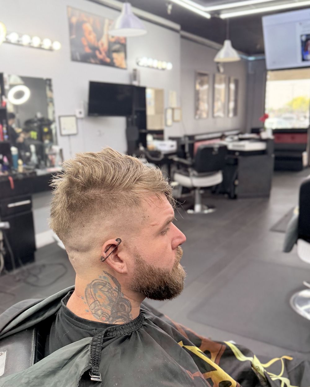 Slick back with a low fade and a full beard